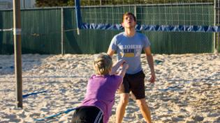 A student dives for the ball on Cedarville's sand volleyball court